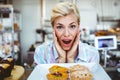 Puzzled pretty woman looking at a fruit pie