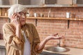 Puzzled senior lady talking on mobile phone Royalty Free Stock Photo