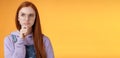 Puzzled serious-looking smart young redhead girl confused thinking deep focus problem touch chin frowning look upper Royalty Free Stock Photo