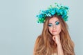 Puzzled upset young Woman with floral headband looking down