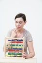 Puzzled Woman Using Abacus