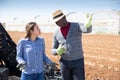 Puzzled workwoman talking to farmer