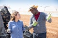 Puzzled workwoman talking to farmer