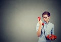 Puzzled young man speaking on phone Royalty Free Stock Photo