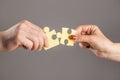 Puzzles. Man and woman holds in hand a jigsaw puzzle. Business solutions, success and strategy concept. Hands connecting Royalty Free Stock Photo