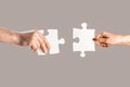 Puzzles. Man and woman holds in hand a jigsaw puzzle. Business solutions, success and strategy concept. Hands connecting Royalty Free Stock Photo