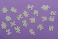 Puzzles on a purple background as a symbol of autism. Conceptual vision of the problem of autistic children