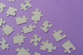 Puzzles on a purple background as a symbol of autism. Conceptual vision of the problem of autistic children