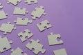 Puzzles on a purple background as a symbol of autism. Conceptual vision of the problem of autistic children