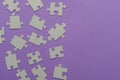 Puzzles on a purple background as a symbol of autism. Conceptual vision of the problem of autistic children