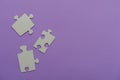 Puzzles on a purple background as a symbol of autism. Conceptual vision of the problem of autistic children