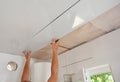 PVC Ceiling Panels, Cladding Installation. Builder installing, renovate, repair white PVC Ceiling Boards in the bathroom Royalty Free Stock Photo