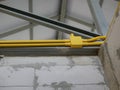 PVC electrical conduits / pipes are installed above house walls on steel bars for power and lighting