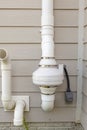 PVC pipes attached to the electrical motor of a residential radon mitigation system.