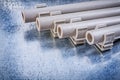 Pvc water-pipes pipe clamps on metallic background construction