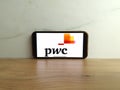 PwC logo displayed on mobile phone