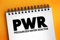 PWR - Pressurized Water Reactor acronym text on notepad, abbreviation concept background