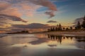 Cloudy dusk reflected on wet sand beach Royalty Free Stock Photo