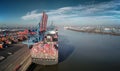 Aerial view of a container ship in the port of Hamburg at a terminal in sunny weather