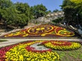 Pyatigorsk, Russia - August 16, 2022: Beautiful view of the flower clock in the city of Pyatigorsk. People climb the stairs to the