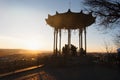 Silhouettes of tourists and a Chinese Gazebo on Mount Goryachaya at sunset. Royalty Free Stock Photo