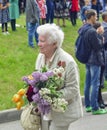 PYATIGORSK, RUSSIA - MAY 09, 2017: War veteran woman with flowers on the Victory Day celebration