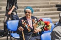 War veteran woman with flowers on the Victory Day celebration Royalty Free Stock Photo