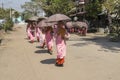 Long queu of Buddhist novice nuns collecting morning alms