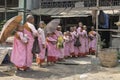 Burmese Buddhist novice nuns queuing up for alms