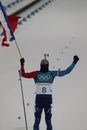 Olympic champion Martin Fourcade of France celebrates victory in biathlon men`s 12.5km pursuit at the 2018 Winter Olympics Royalty Free Stock Photo