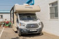 Ford camper van parked behind Korean fishing supply store