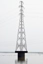 Pylon power electricity tower crossing river water on pier Royalty Free Stock Photo