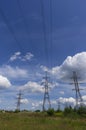 Pylons of high-voltage power transmission lines against a blue sky Royalty Free Stock Photo