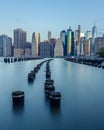 View of Lower Manhattan New York Skyline from Old Pier 1 in Brooklyn with Pylons in the East River Royalty Free Stock Photo