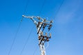 The pylons of a power line with blue sky