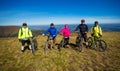 Pylypets, Ukraine - 15 September, 2019: Five friends on bicycles are happy on top of mountains