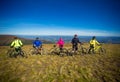 Pylypets, Ukraine - 15 September, 2019: Five friends on bicycles are happy on top of mountains