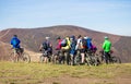 Pylypets, Ukraine - 15 September, 2019: Group of tourists friends ride bicycles along the top of mountains