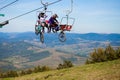 Pylypets, Ukraine - 15 September, 2019: Mountain bikers on chair lift in mountain. Carpathians, Ukraine