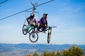 Pylypets, Ukraine - 15 September, 2019: Mountain bikers on chair lift in mountain. Carpathians, Ukraine