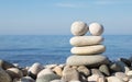 Pyramid of balanced stones on the background of the sea. Selective focus Royalty Free Stock Photo