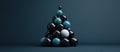 A pyramid of black and blue spheres with a single white sphere in the middle Royalty Free Stock Photo