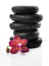 Pyramid of black zen stones and red orchid, phalaenopsis Royalty Free Stock Photo