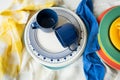 A pyramid of brightly colored bowls, plates and cups of different sizes and colors on the kitchen table. Scandinavian Royalty Free Stock Photo