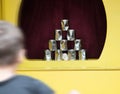 Pyramid of cans down rag ball Royalty Free Stock Photo