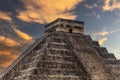 The pyramid of Chichen Itza in honor of the God Kukulkan under a beautiful tropical orange sunset Royalty Free Stock Photo