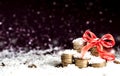 Pyramid of coins and the coins scattered over in the snow