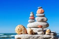 Pyramid of colorful rocks and shells on the sea background. The Royalty Free Stock Photo