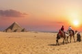 The Pyramid complex of Giza and arabs on camels, Egypt Royalty Free Stock Photo