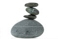 A pyramid of four stones in balance is isolated on a white background Royalty Free Stock Photo